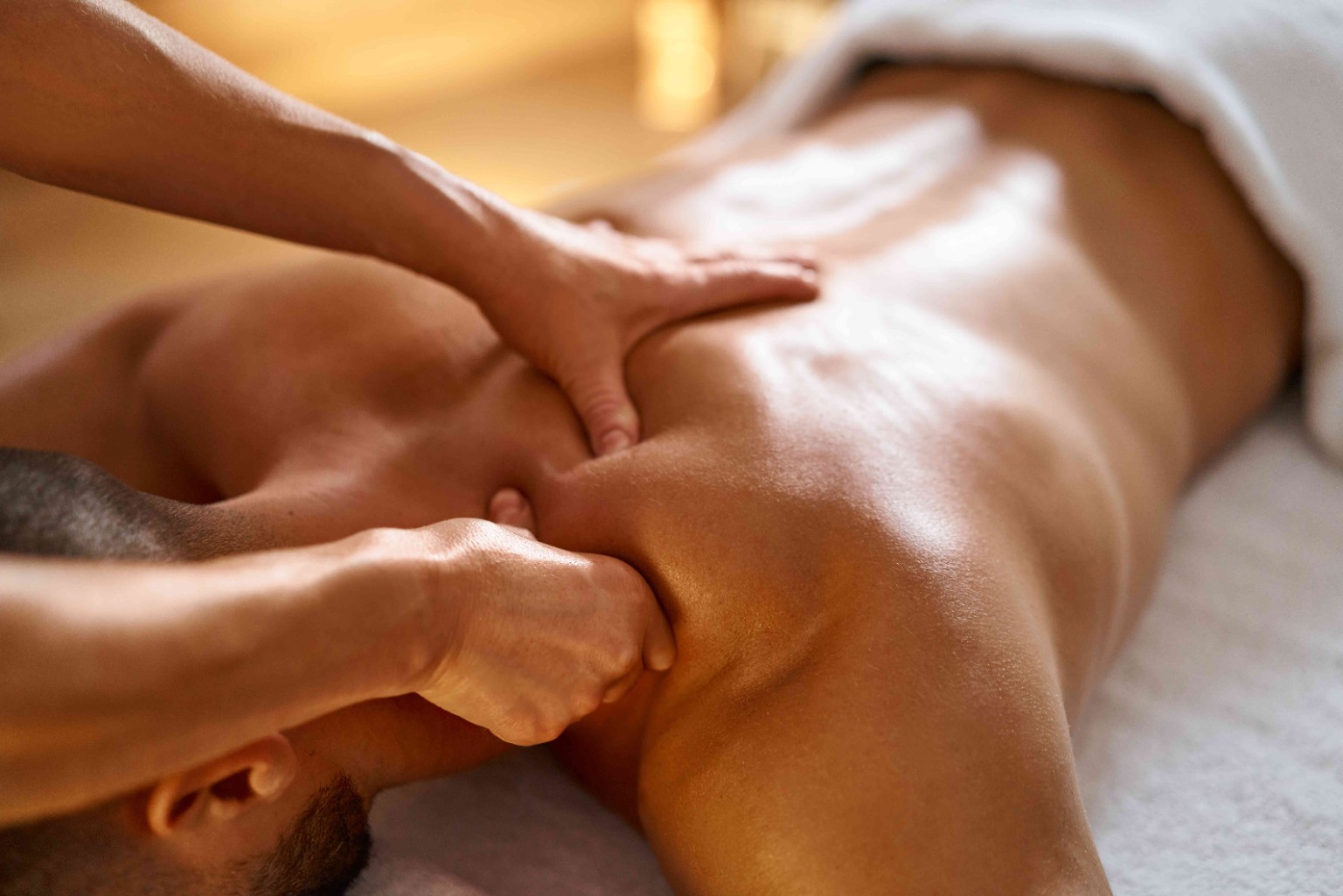 Massage therapist providing therapeutic massage treatment