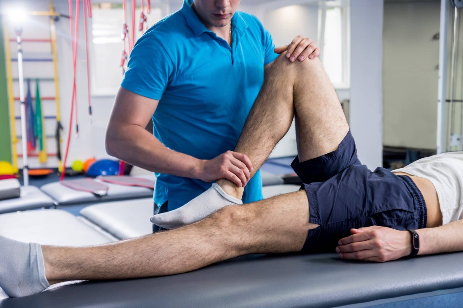 Physical therapist providing guided rehabilitation treatment for a patient